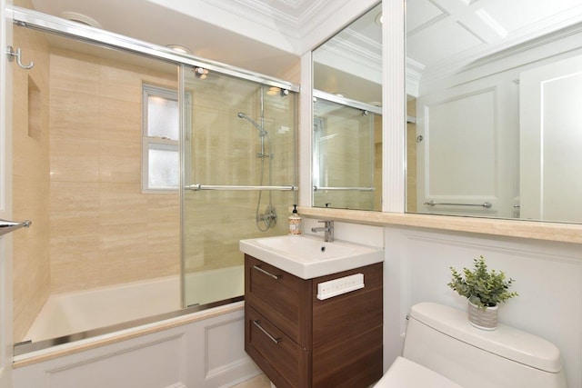 full bathroom with enclosed tub / shower combo, crown molding, vanity, and toilet