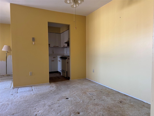 spare room featuring light colored carpet