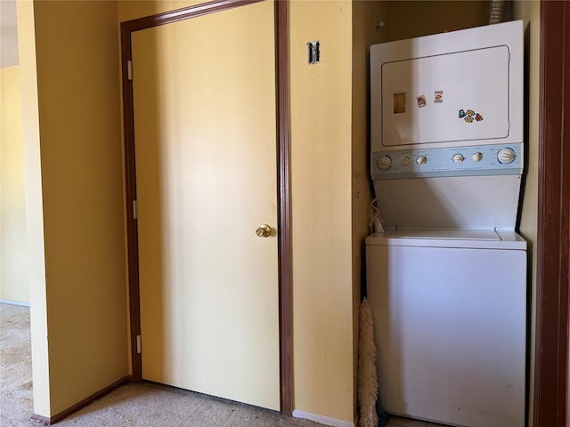 laundry area with light carpet, laundry area, and stacked washer and clothes dryer