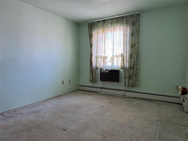 carpeted empty room featuring a baseboard heating unit