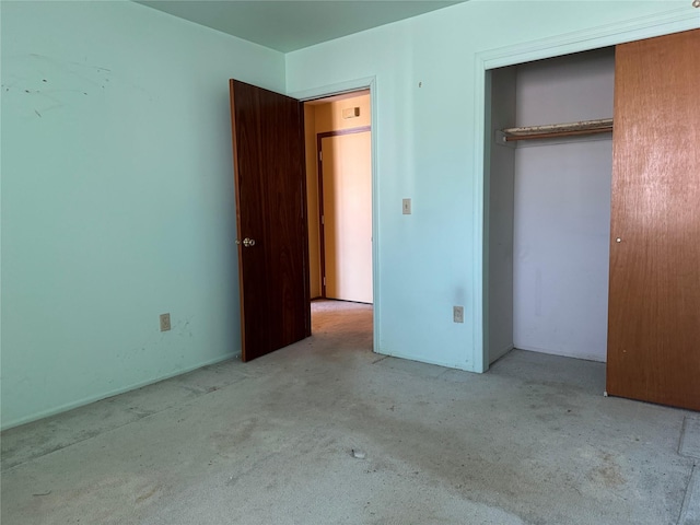 unfurnished bedroom with carpet floors and a closet