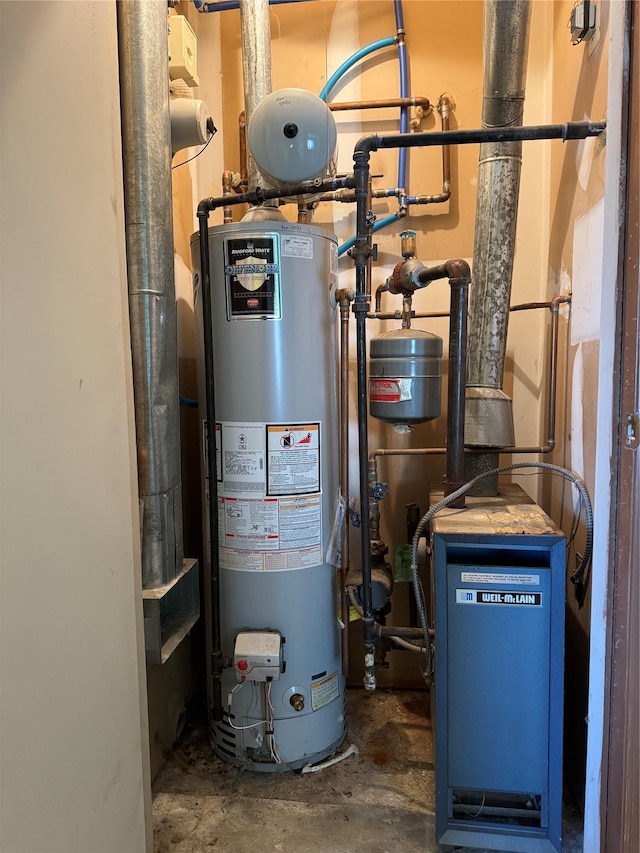 utility room featuring water heater and a heating unit