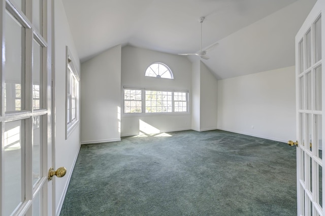 additional living space with french doors, a ceiling fan, carpet flooring, high vaulted ceiling, and baseboards