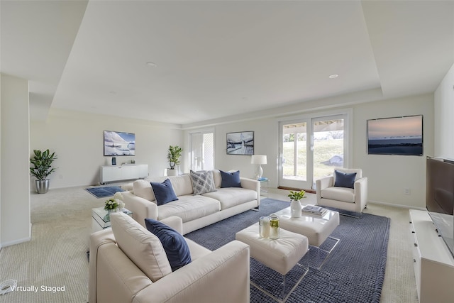 living room featuring carpet floors and baseboards