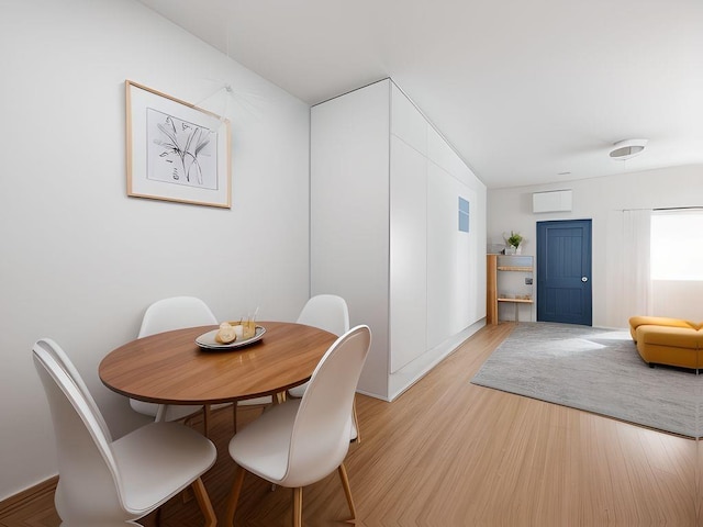 dining space featuring light wood finished floors