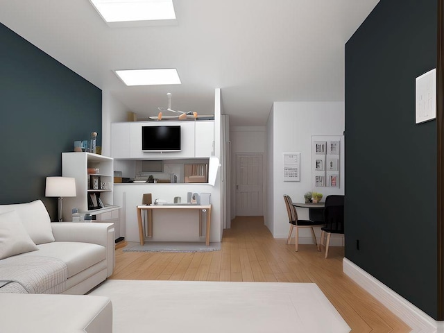 living area with baseboards, wood finished floors, and a skylight