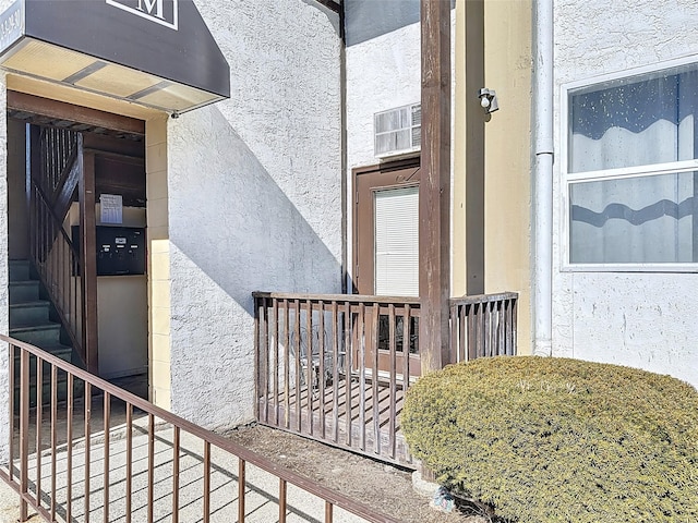 property entrance with stucco siding