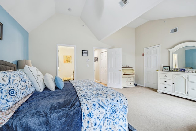 bedroom with high vaulted ceiling, visible vents, connected bathroom, and light colored carpet