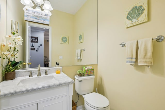 half bathroom with vanity and toilet