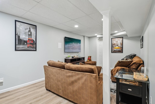 living room featuring recessed lighting, a drop ceiling, light wood-style flooring, and baseboards