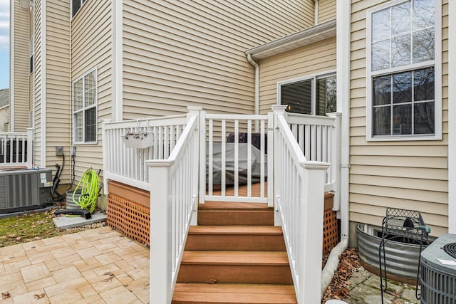 entrance to property with central air condition unit and a patio