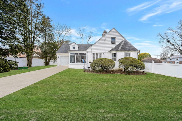 view of front of house with fence, a sunroom, driveway, a chimney, and a front yard