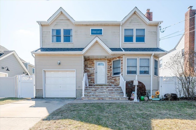 view of front of property featuring a garage, driveway, a chimney, fence, and a front yard