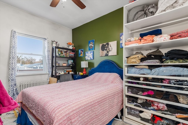 bedroom featuring radiator heating unit and ceiling fan