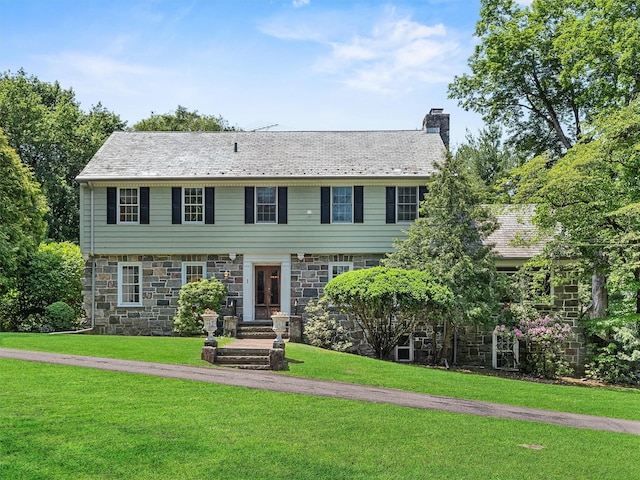 1 Finnegan Ln, Montebello, NY 10901 - colonial inspired home featuring a chimney, stone siding, and a front lawn