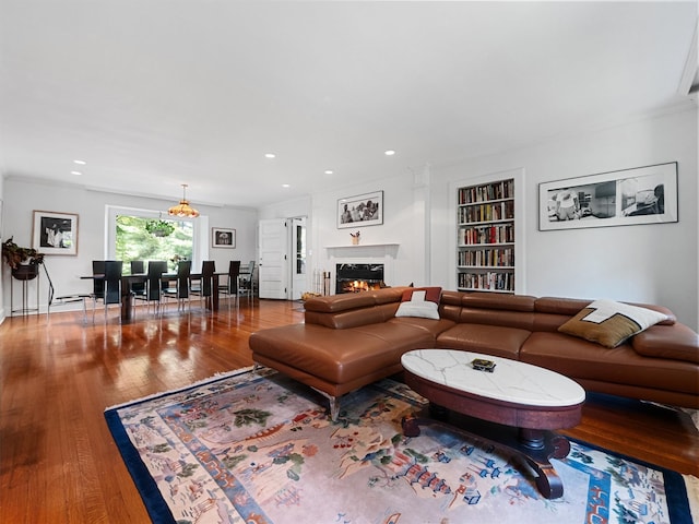 1 Finnegan Ln, Montebello, NY 10901 - living area featuring built in shelves, hardwood / wood-style floors, a lit fireplace, and recessed lighting