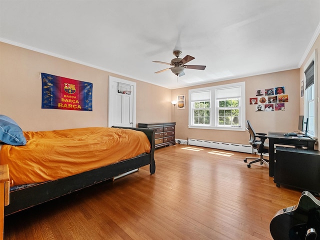 1 Finnegan Ln, Montebello, NY 10901 - bedroom featuring a baseboard heating unit, wood finished floors, crown molding, and a ceiling fan