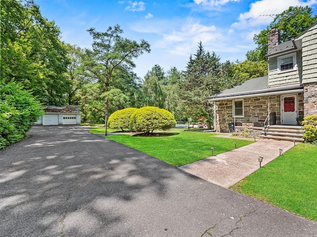 1 Finnegan Ln, Montebello, NY 10901 - view of grassy yard featuring a detached garage and an outdoor structure