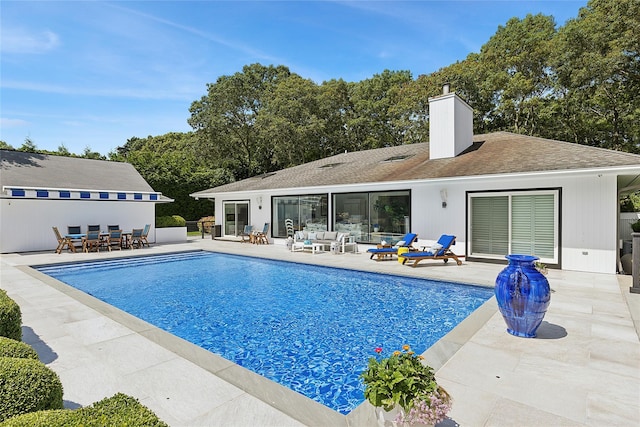 pool with a patio area and outdoor lounge area