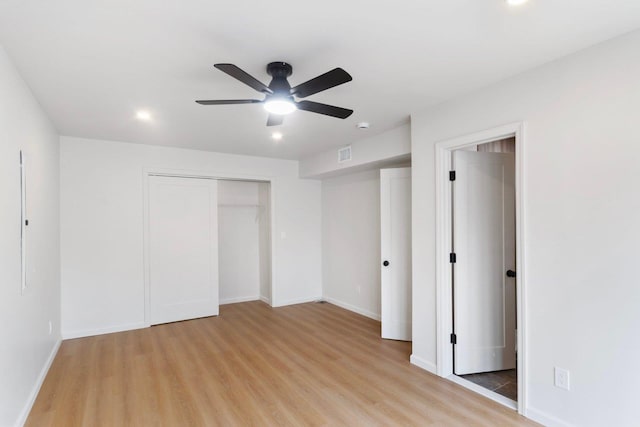 unfurnished bedroom featuring a ceiling fan, light wood-type flooring, visible vents, and baseboards