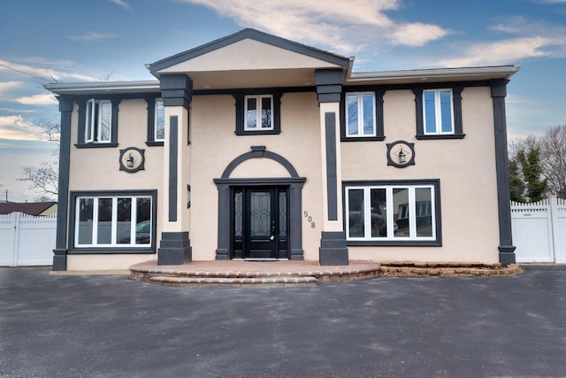 view of front of home with fence and stucco siding