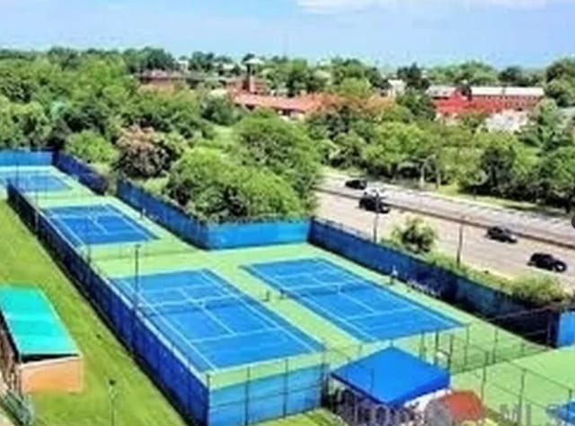 view of tennis court featuring fence