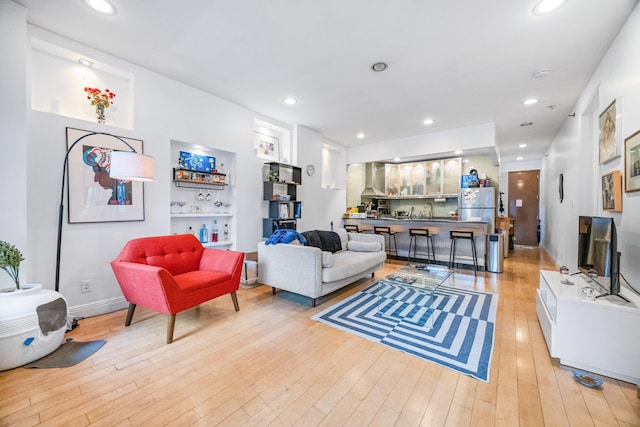 living room featuring light wood-style flooring and recessed lighting