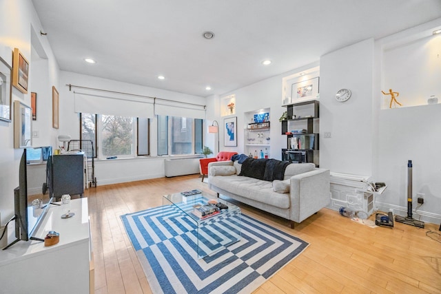 living area featuring hardwood / wood-style flooring, baseboards, and recessed lighting