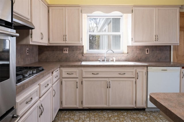 kitchen with decorative backsplash, white dishwasher, under cabinet range hood, stainless steel gas cooktop, and a sink