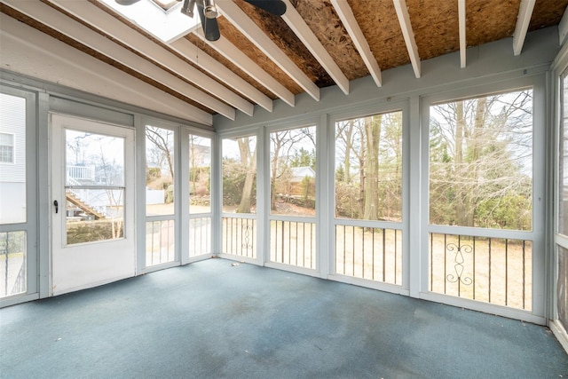 unfurnished sunroom featuring a ceiling fan