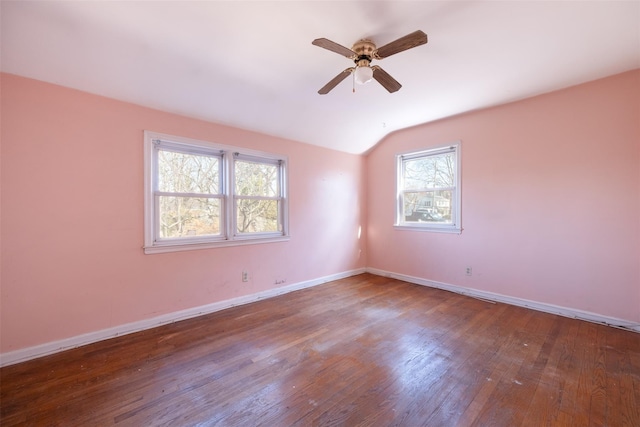 unfurnished room with vaulted ceiling, ceiling fan, hardwood / wood-style flooring, and baseboards