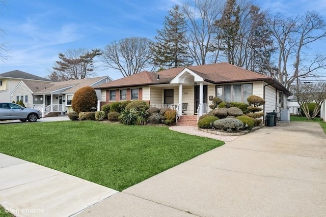 view of front facade featuring a front lawn, a porch, and concrete driveway