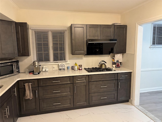 kitchen with black gas cooktop, marble finish floor, stainless steel microwave, and ornamental molding