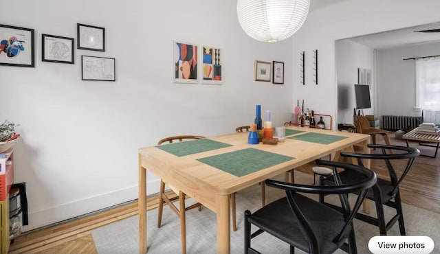 dining area featuring baseboards and radiator heating unit