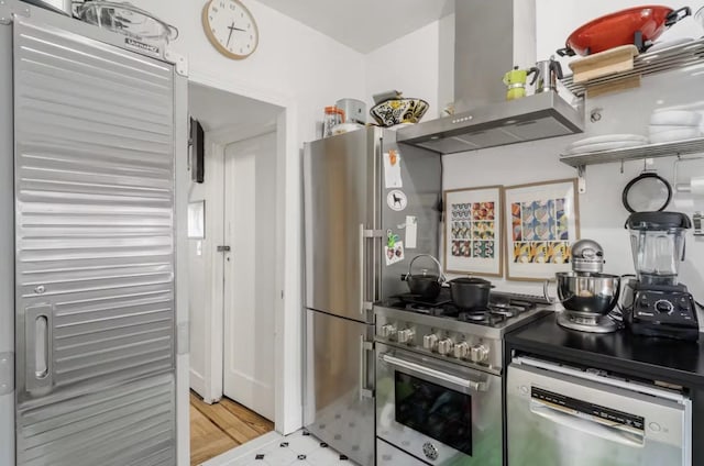 kitchen featuring wall chimney range hood, appliances with stainless steel finishes, and open shelves