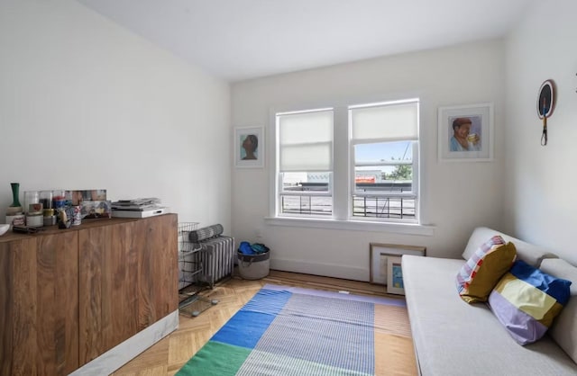 bedroom with baseboards and radiator