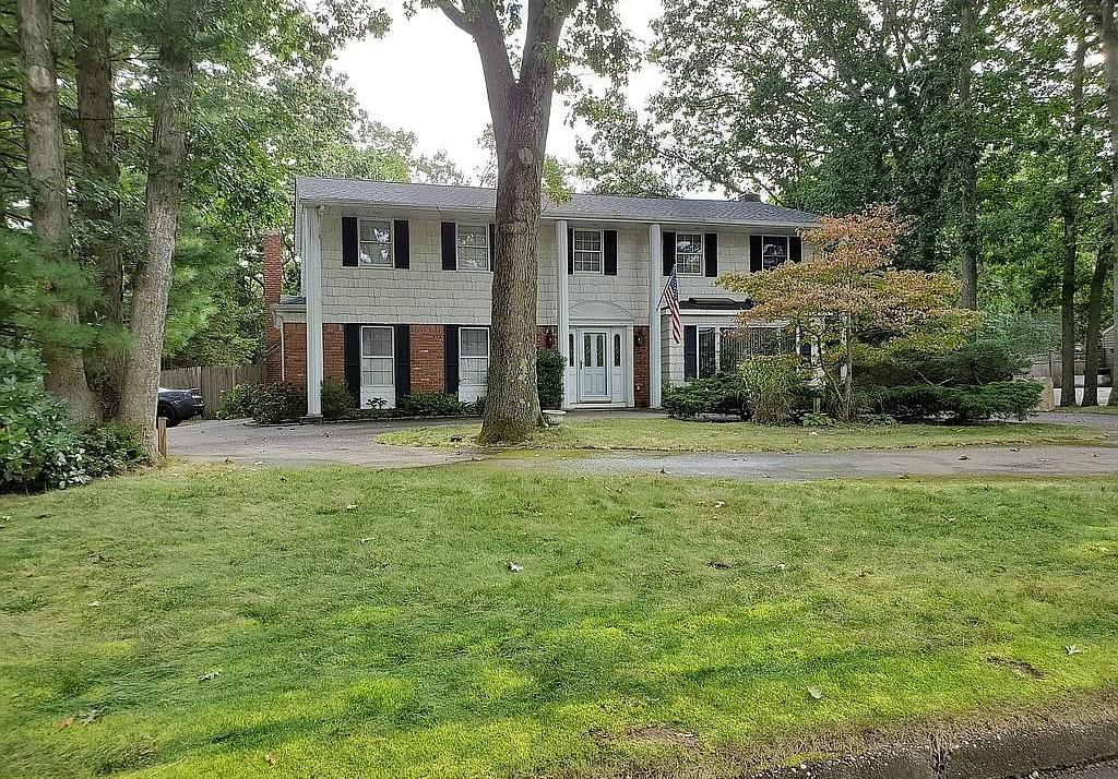2 Scott Ct, Lake Grove, NY 11755 - view of front of house with brick siding and a front yard