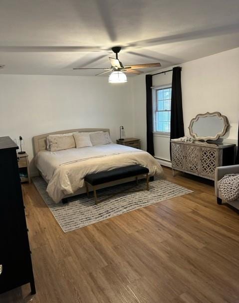 bedroom with ceiling fan and wood finished floors