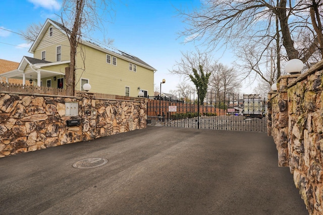 exterior space with solar panels, a gate, and fence