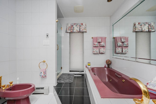 bathroom with a jetted tub, tile walls, a stall shower, and tile patterned flooring