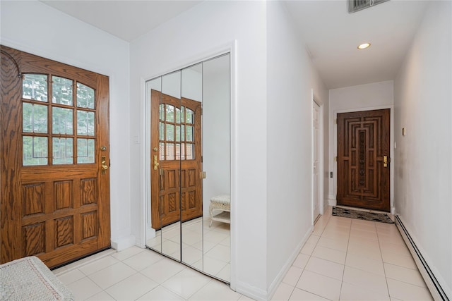 foyer entrance featuring light tile patterned floors, recessed lighting, visible vents, and a baseboard radiator