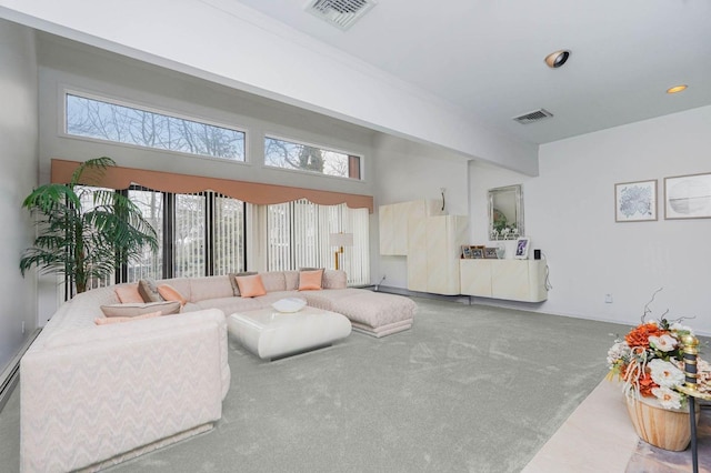 living area with visible vents and carpet flooring