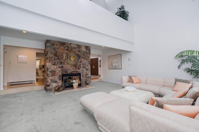 living room featuring baseboard heating, a high ceiling, and carpet floors