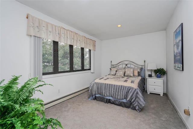 carpeted bedroom featuring a baseboard heating unit, recessed lighting, and baseboards