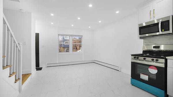 kitchen with appliances with stainless steel finishes, recessed lighting, marble finish floor, and white cabinets