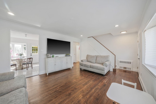 living room with baseboards, recessed lighting, wood finished floors, and radiator