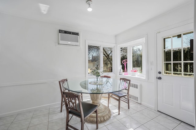 dining space featuring radiator heating unit, a wall mounted AC, light tile patterned flooring, and baseboards