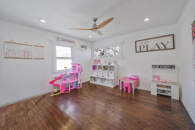 game room featuring recessed lighting, wood finished floors, a ceiling fan, baseboards, and an AC wall unit