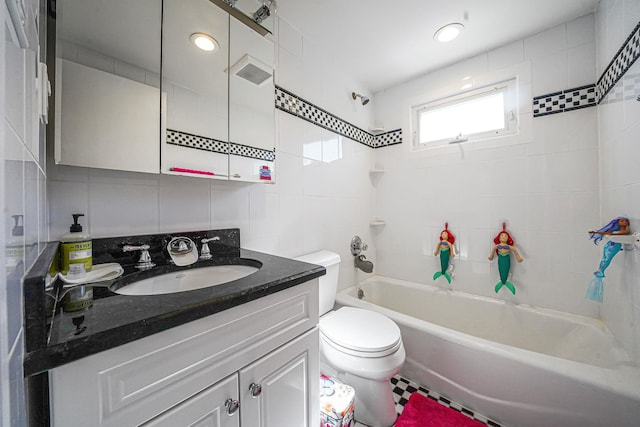 bathroom with tile walls, shower / bathtub combination, tasteful backsplash, toilet, and vanity