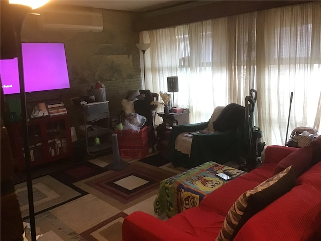 living area featuring a wealth of natural light and a wall mounted air conditioner